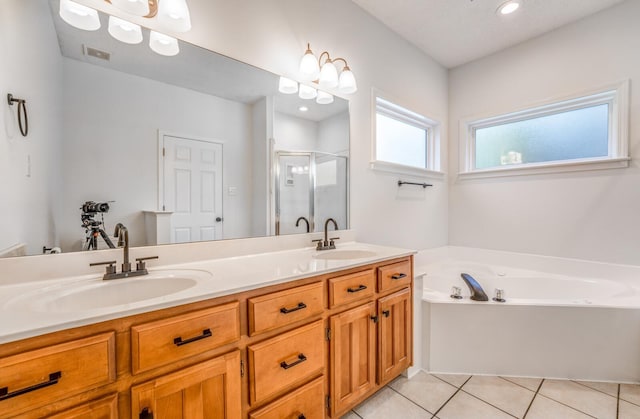 bathroom featuring tile patterned flooring, vanity, and shower with separate bathtub