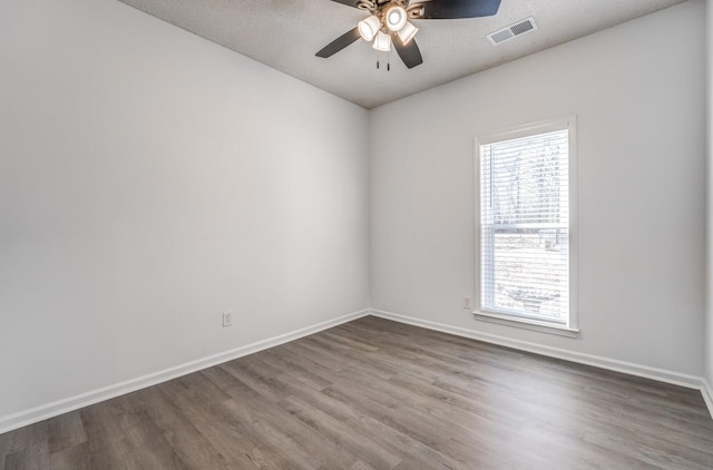 unfurnished room with wood-type flooring, a textured ceiling, and ceiling fan