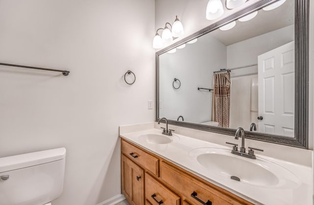 bathroom featuring toilet, a shower with shower curtain, and vanity