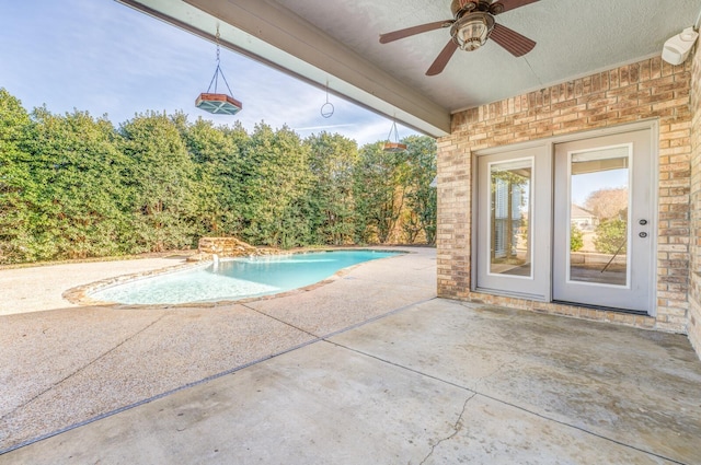 view of swimming pool with a patio area, pool water feature, and ceiling fan