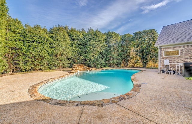 view of pool featuring central air condition unit and a patio area