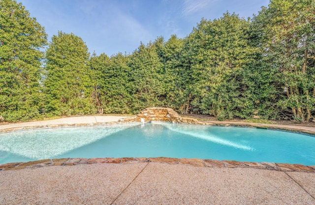 view of swimming pool with pool water feature