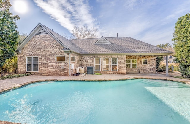 view of swimming pool with a patio area and central AC unit