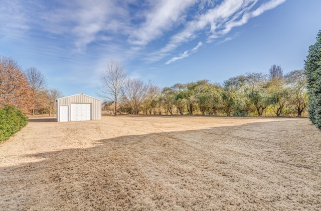 view of yard with an outbuilding and a garage