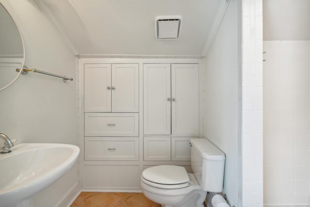 bathroom with sink, toilet, crown molding, and tile patterned flooring