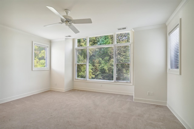 empty room with light carpet, ceiling fan, and ornamental molding