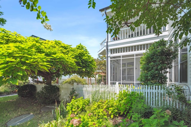 view of property exterior featuring a sunroom