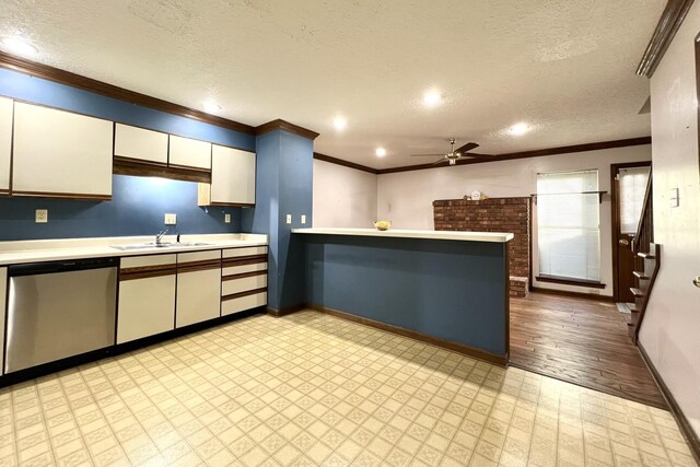 kitchen featuring crown molding, sink, stainless steel dishwasher, and a textured ceiling