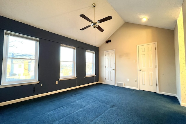 unfurnished bedroom with high vaulted ceiling, ceiling fan, and dark colored carpet