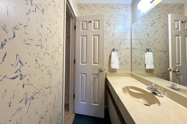 bathroom with vanity, tile patterned flooring, and a textured ceiling