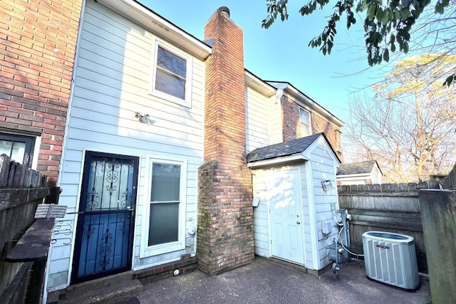 rear view of property with central air condition unit