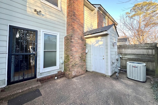 property entrance with central AC unit and a patio area