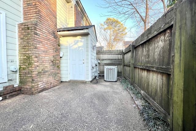 view of property exterior featuring central AC unit and a patio area