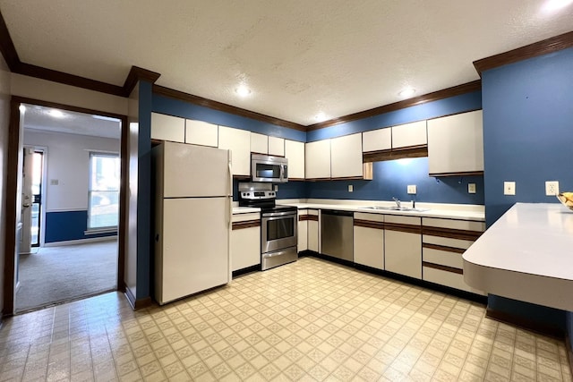 kitchen with stainless steel appliances, sink, white cabinets, and a textured ceiling