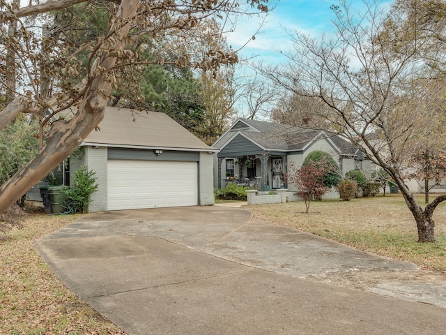 ranch-style home featuring a garage, a front lawn, and covered porch