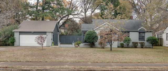 single story home featuring a garage and a front yard