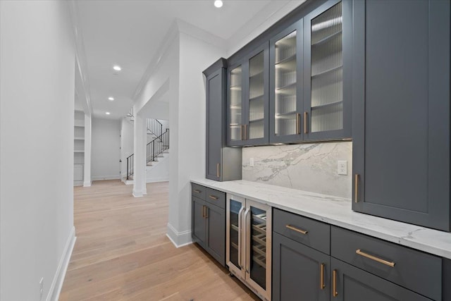 9170 Old Green Ln, Germantown, TN 38138 - indoor dry bar featuring wine cooler, backsplash, light wood finished floors, recessed lighting, and stairway