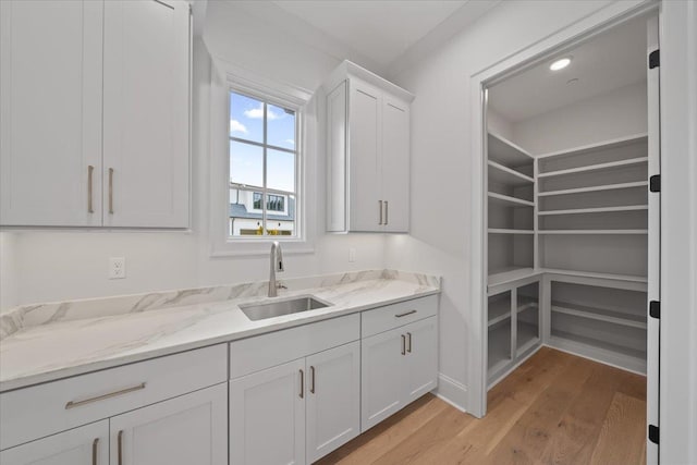 9170 Old Green Ln, Germantown, TN 38138 - kitchen with light wood-type flooring, white cabinetry, and light stone counters