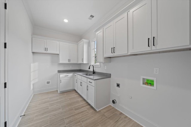 9170 Old Green Ln, Germantown, TN 38138 - laundry room with hookup for an electric dryer, hookup for a gas dryer, washer hookup, cabinet space, and wood tiled floors