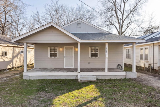 view of front facade with a front lawn and a porch