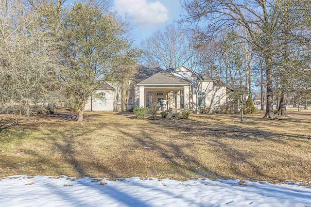 view of front of property featuring covered porch and a lawn