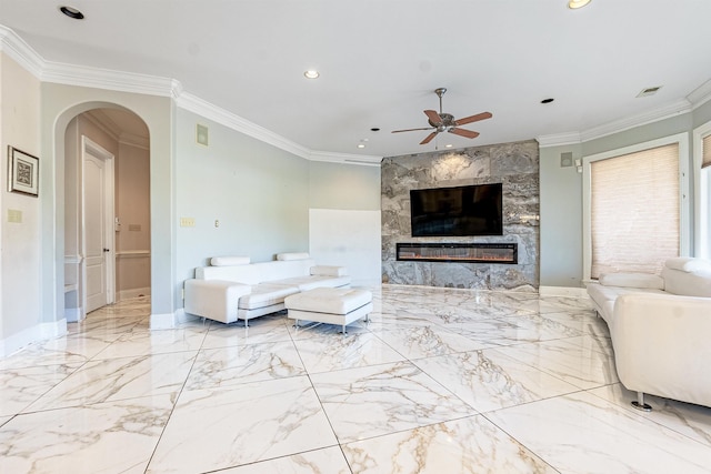 living room featuring a fireplace, ceiling fan, and ornamental molding