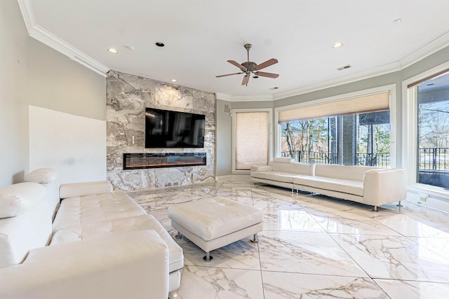 living room with ceiling fan, ornamental molding, and a fireplace