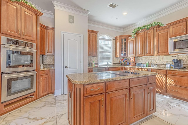 kitchen with a kitchen island, stainless steel appliances, sink, backsplash, and crown molding