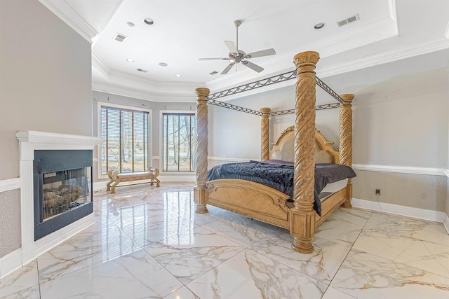 bedroom featuring ceiling fan, crown molding, and a raised ceiling