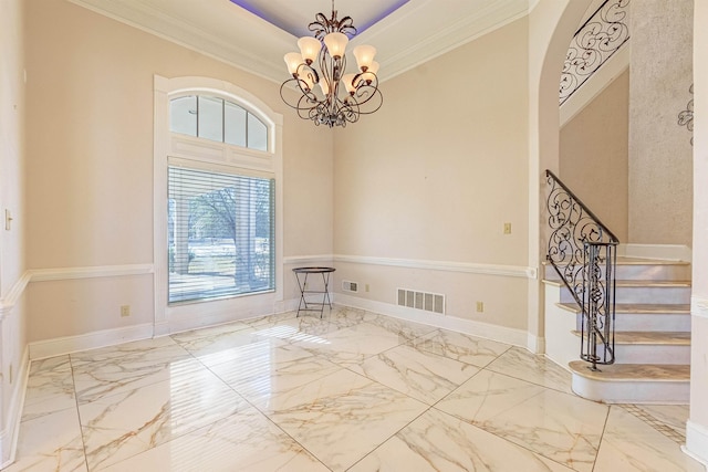 unfurnished room with an inviting chandelier, crown molding, and a tray ceiling