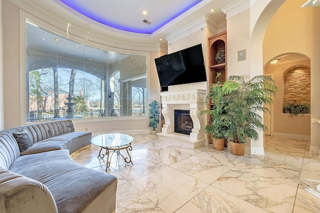 living room with a tray ceiling and crown molding