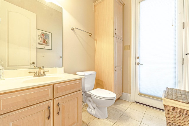 bathroom featuring toilet, tile patterned floors, and vanity