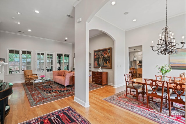 dining area featuring hardwood / wood-style floors, ornamental molding, and french doors