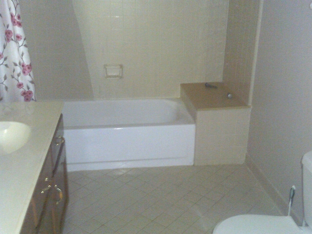 full bathroom featuring tile patterned flooring, vanity, shower with separate bathtub, and toilet