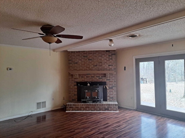 unfurnished living room featuring hardwood / wood-style flooring, ceiling fan, and a textured ceiling