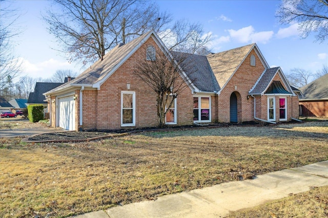 view of front of property with a garage and a front lawn