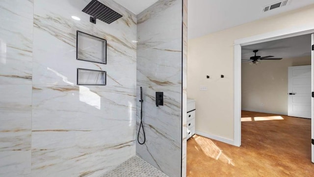 bathroom featuring vanity, ceiling fan, and tiled shower