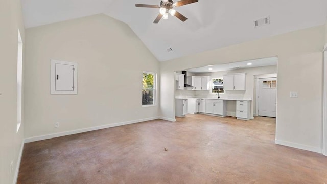 unfurnished living room with ceiling fan, electric panel, and lofted ceiling