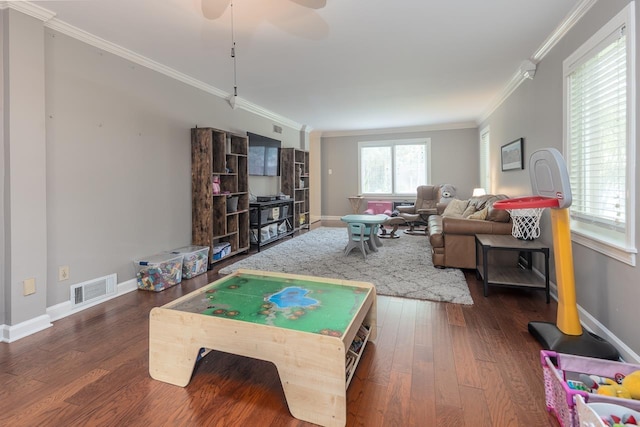 playroom with ornamental molding, dark hardwood / wood-style floors, and ceiling fan