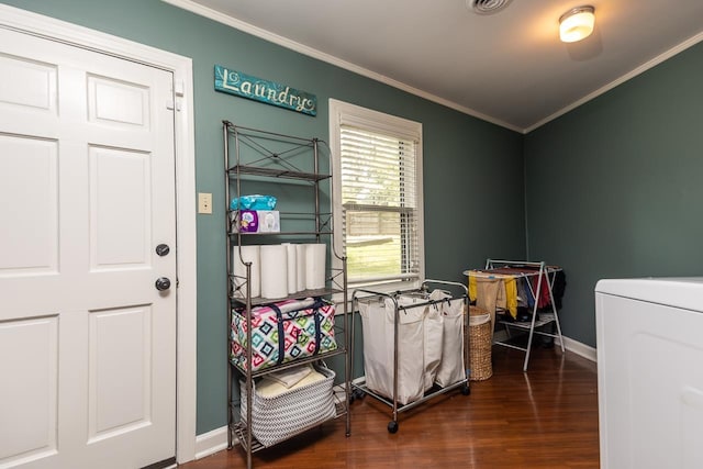 miscellaneous room featuring washer / clothes dryer, ornamental molding, and dark wood-type flooring