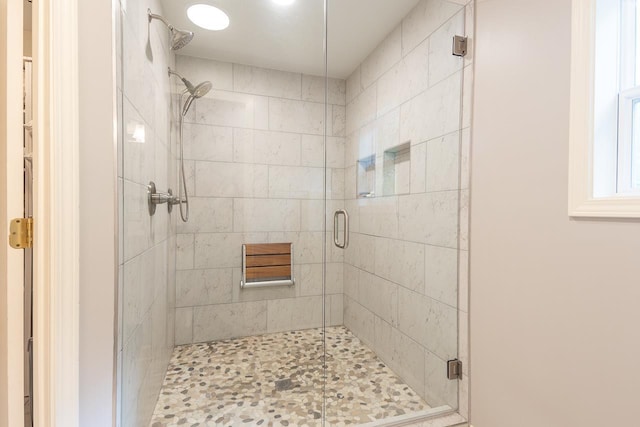 bathroom featuring a shower with door