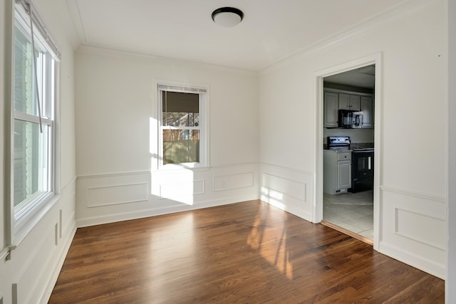 empty room with ornamental molding and dark wood-type flooring