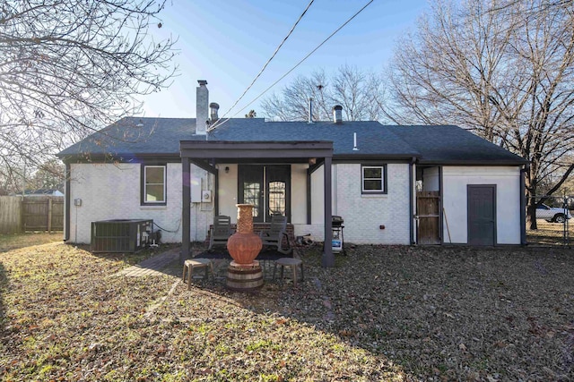 back of property with cooling unit and a patio area