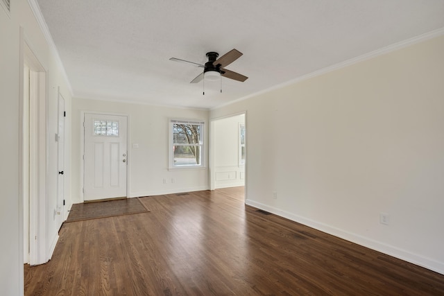 foyer entrance with crown molding, dark wood-type flooring, and ceiling fan