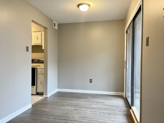 interior space with wood-type flooring and a textured ceiling