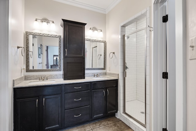 bathroom featuring vanity, crown molding, a shower with door, and tile patterned floors