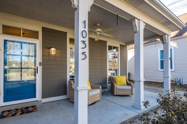 entrance to property with a porch and ceiling fan