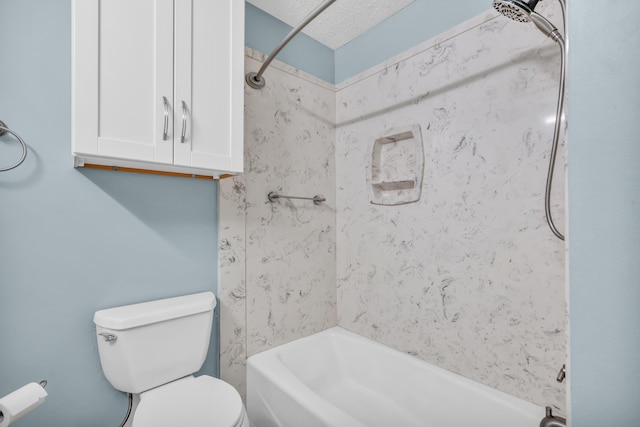 bathroom featuring toilet, shower / bath combination, and a textured ceiling