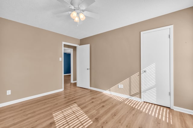 empty room featuring light hardwood / wood-style flooring and ceiling fan