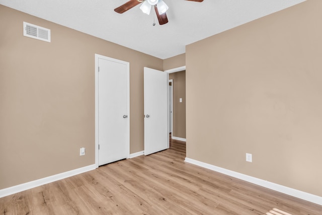 unfurnished bedroom with ceiling fan and light hardwood / wood-style floors